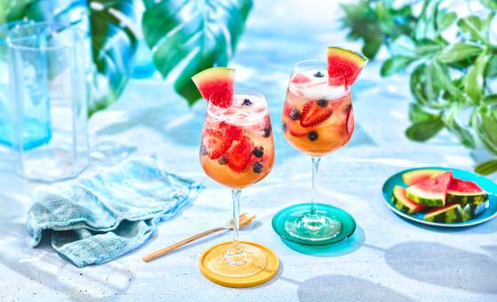 Lemonade iced tea sangria with fresh berries and watermelon.
